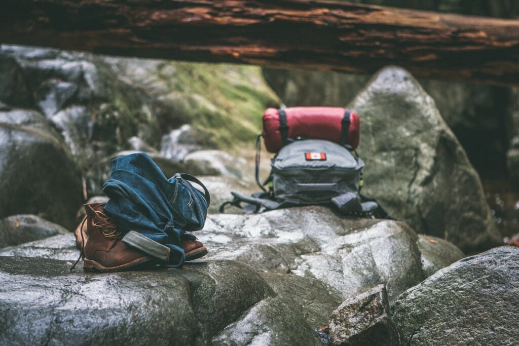 Karakoram trek packing list laid out: down bag, boots, duffel and layers