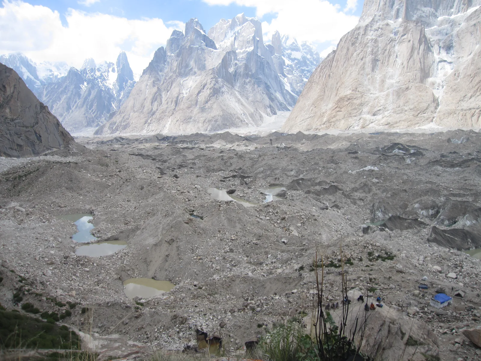 View across the Baltoro Glacier from the grassy Urdukas campsite, with granite Karakoram spires behind