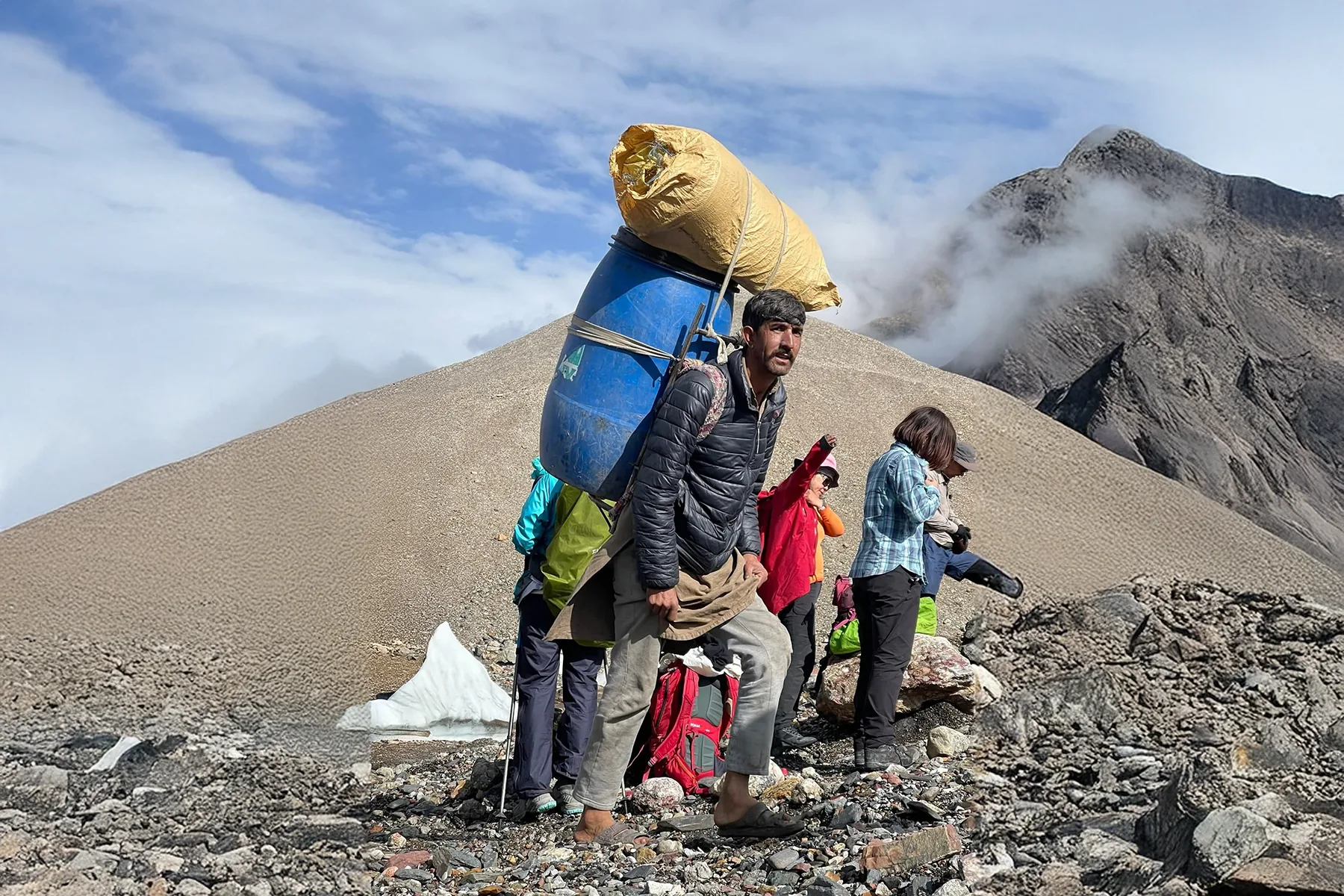 Porter carrying an expedition load on a Karakoram trail