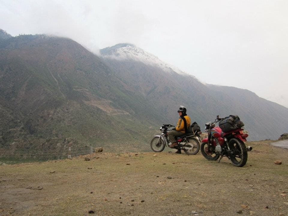 Two touring motorcycles stopped above the Indus valley on the Karakoram Highway in Kohistan